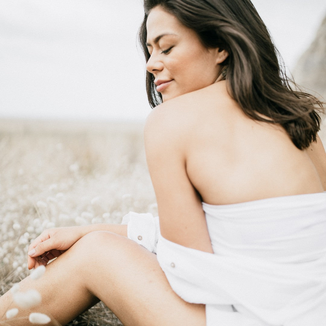 Woman sitting on a beach | Adashiko Collagen | 100% Natural Skincare