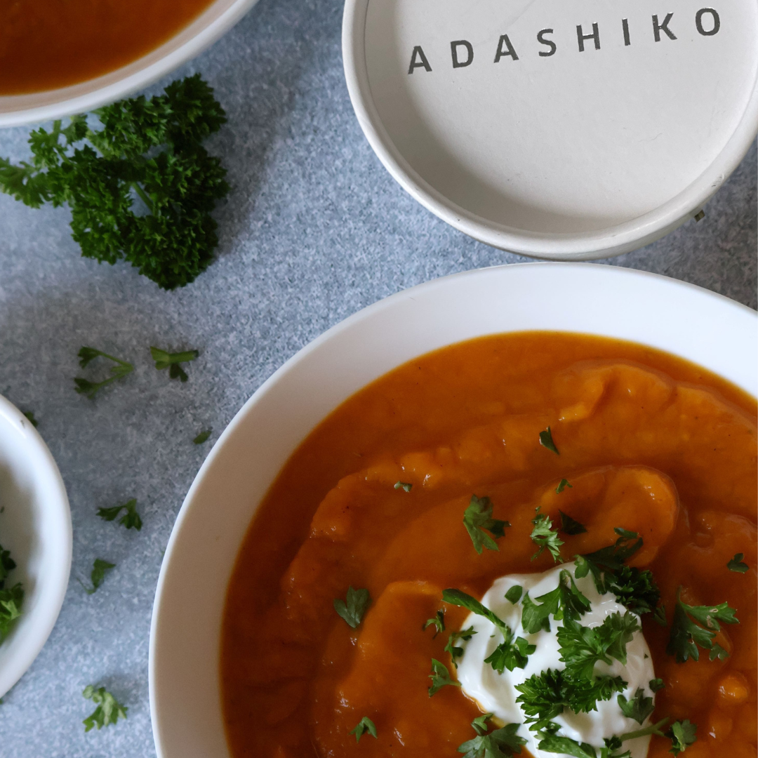 A bowl of Pumpkin + Kumara Collagen Soup next to a tub of Collagen Pure | Adashiko Collagen | 100% Natural Skincare