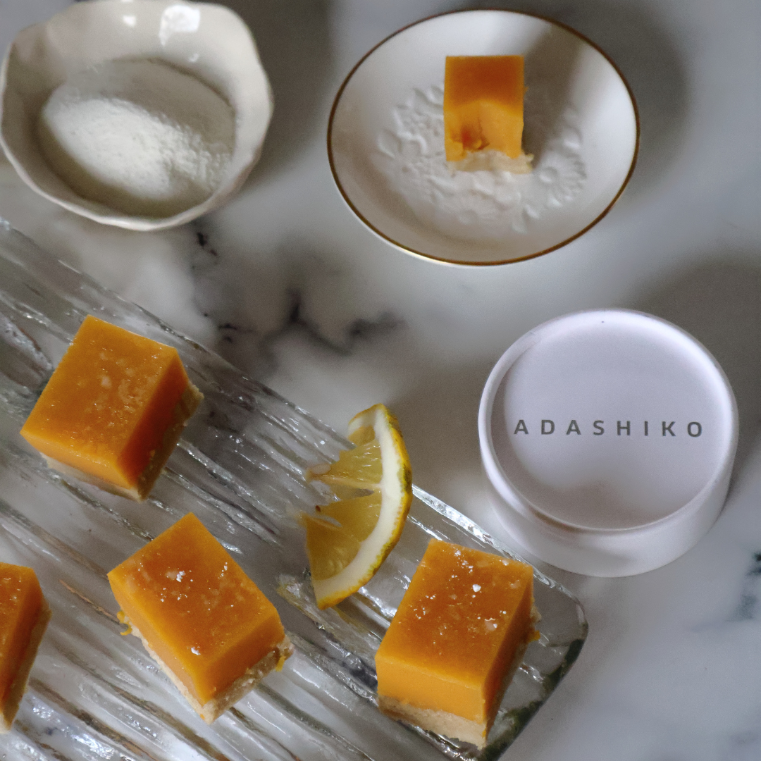 Servings of Lemon Curd Collagen Slice next to a Collagen Pure tub lid | Adashiko Collagen | 100% Natural Skincare