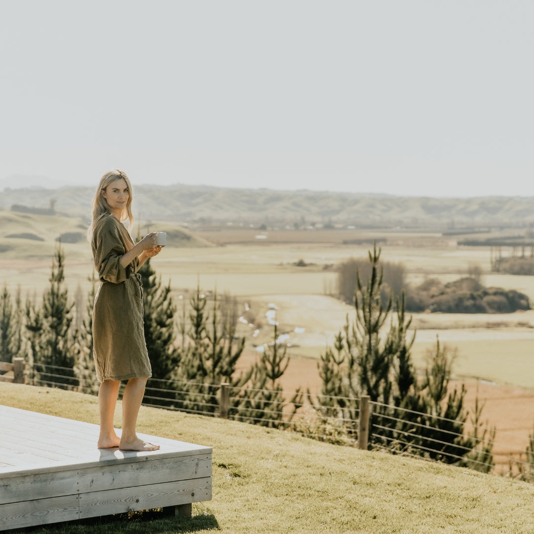 Model standing on deck overlooking paddocks | Adashiko Collagen | 100% Natural Skincare