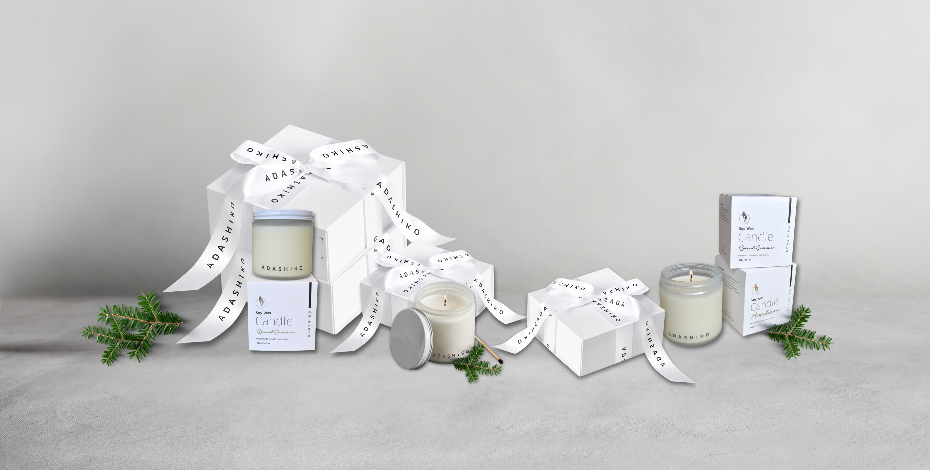 Adashiko Christmas Gift Guide - boxes wrapped in ribbons against a grey background | Adashiko Collagen | 100% Natural Skincare