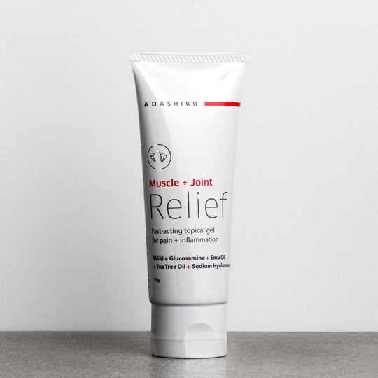 Tube of Muscle + Joint Relief against a grey background | Adashiko Collagen | 100% Natural Skincare