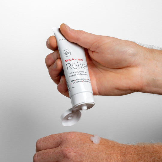 Muscle + Joint Relief being applied to the back of a hand | Adashiko Collagen | 100% Natural Skincare