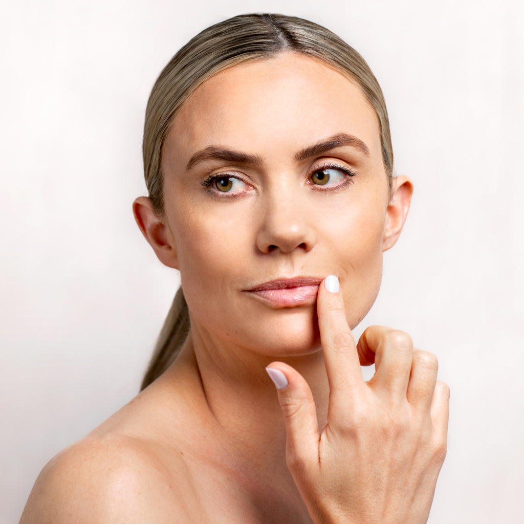 Model applying Collagen Balm to her lips | Adashiko Collagen | 100% Natural Skincare