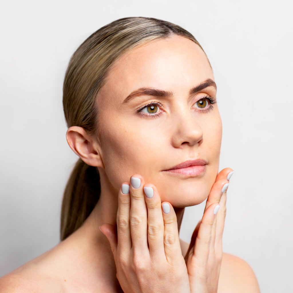 Model applying Hydra+ Gold Elixir to her face | Adashiko Collagen | 100% Natural Skincare
