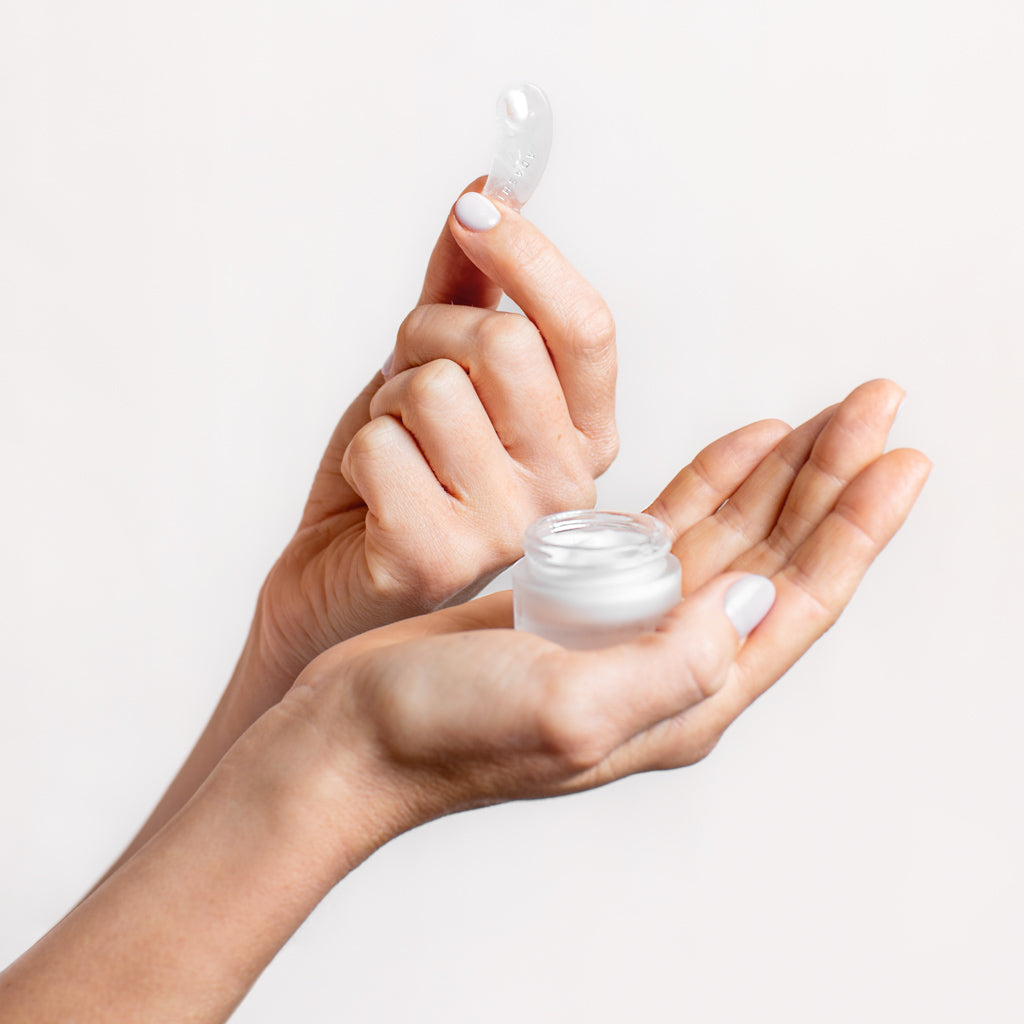 Jar of Silk Repair Eye Cream held in right hand with Quartz Spatula held in left hand | Adashiko Collagen | 100% Natural Skincare