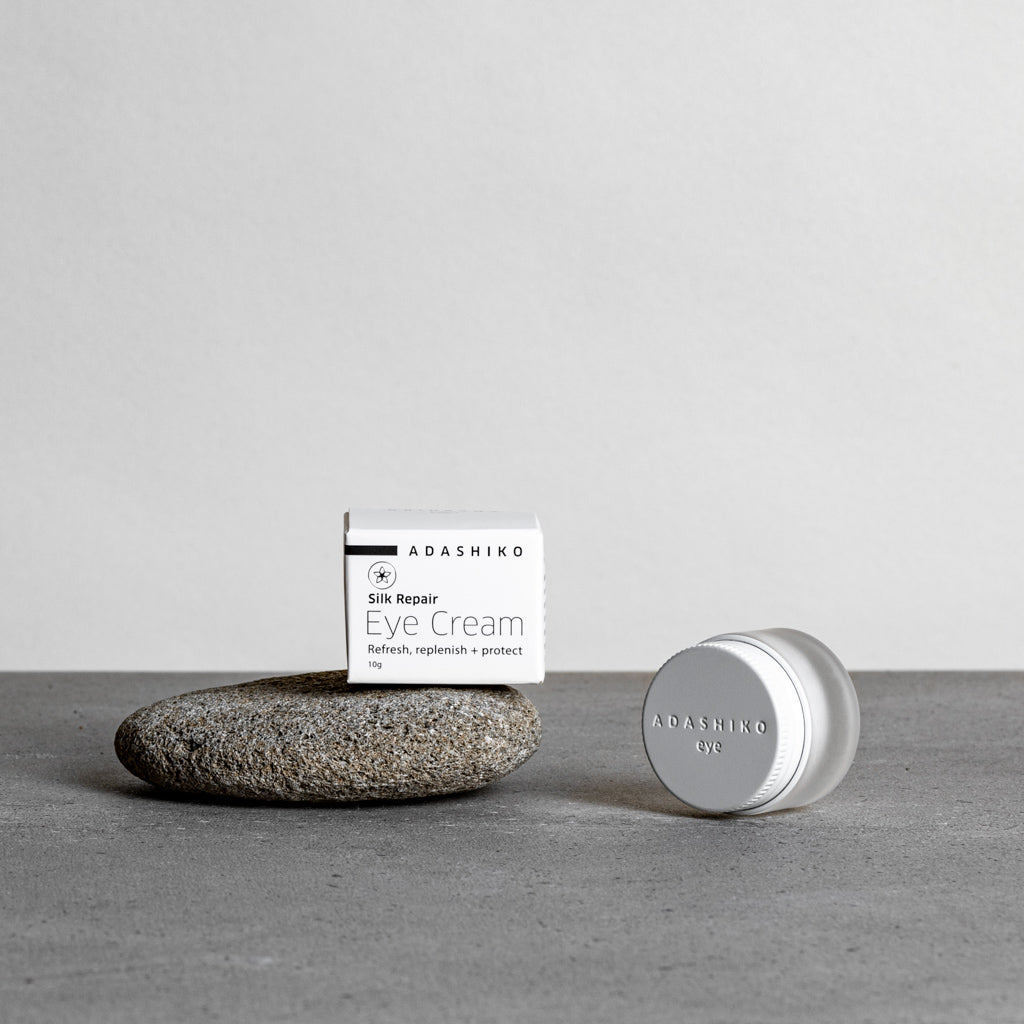 Jar of Silk Repair Eye Cream next to its box against a grey background | Adashiko Collagen | 100% Natural Skincare