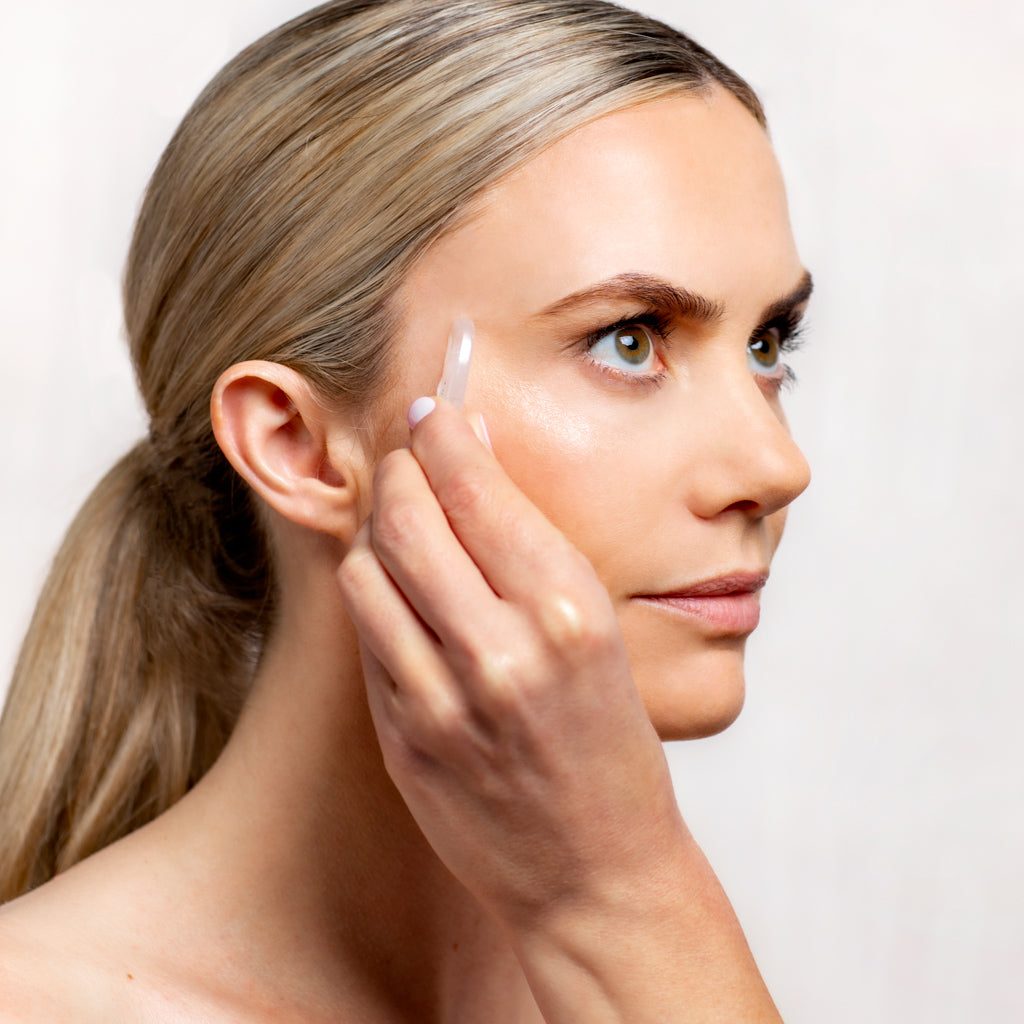 Model applying Silk Repair Eye Cream to her eyes using a Quartz Spatula | Adashiko Collagen | 100% Natural Skincare